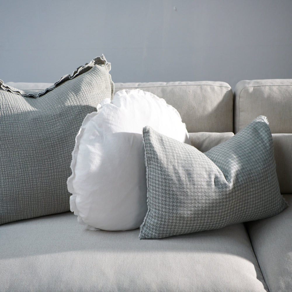houndstooth pattern linen cushion in pistachio with frayed edge feature