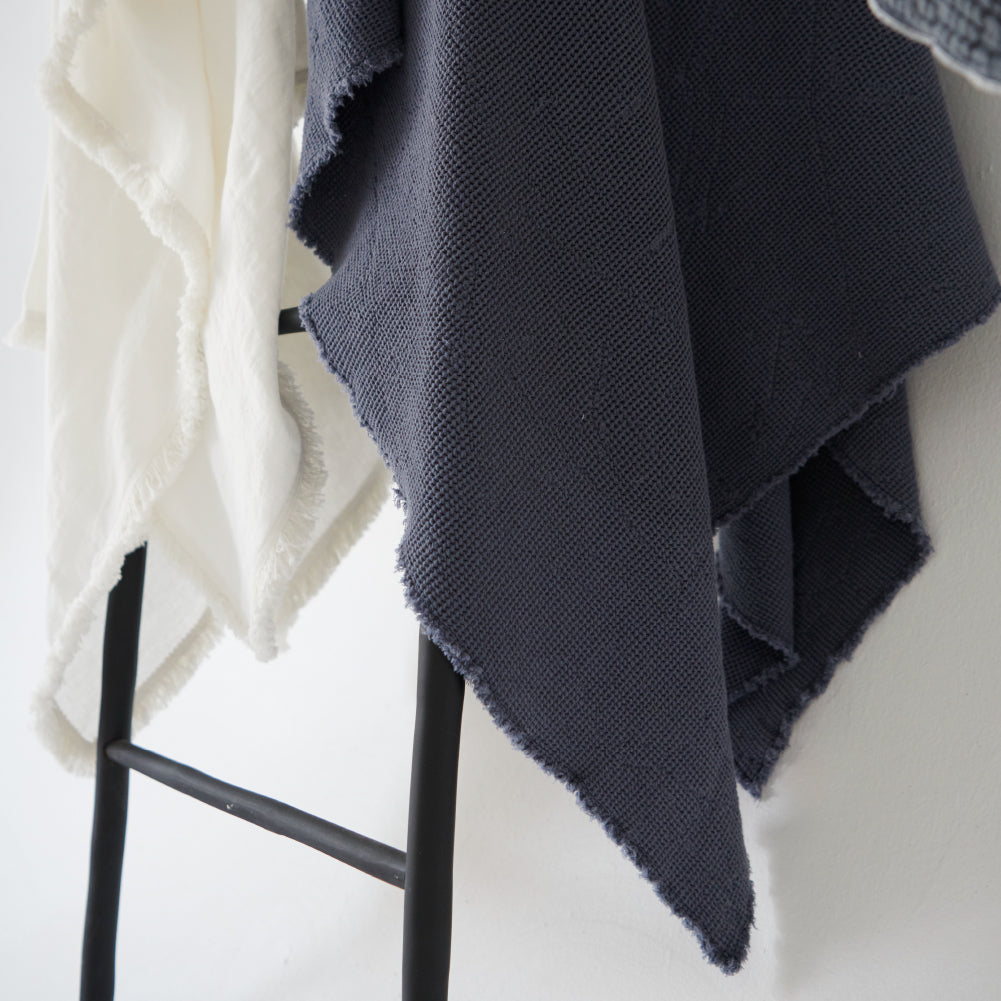 cotton waffle textured throw in navy blue with frayed edge