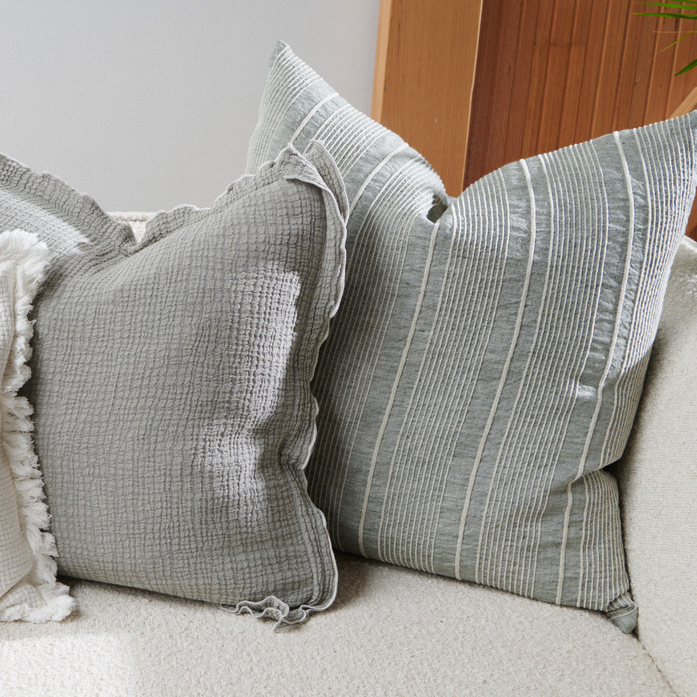 pistachio linen cushion with a white stripe feature 