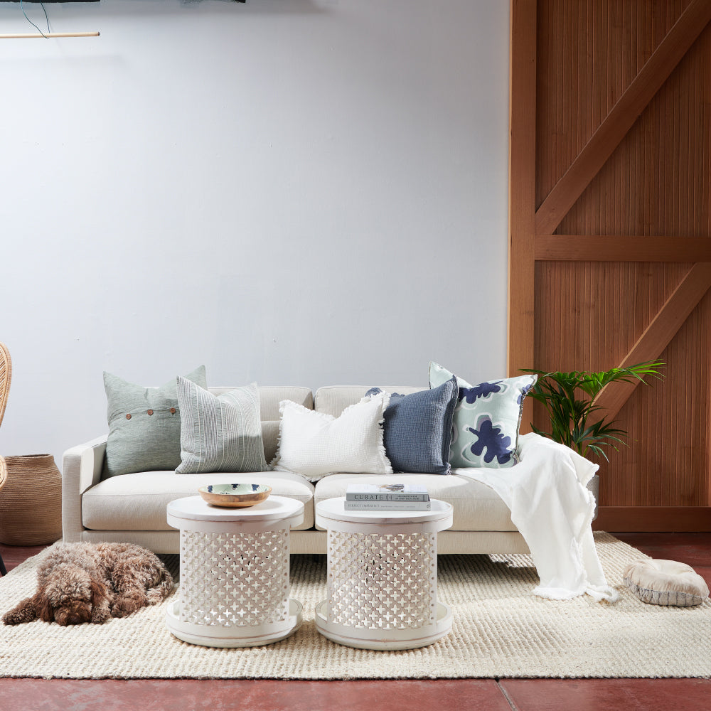 100% linen cushion in a sea mist and navy leaf abstract pattern and a contrast stitch feature
