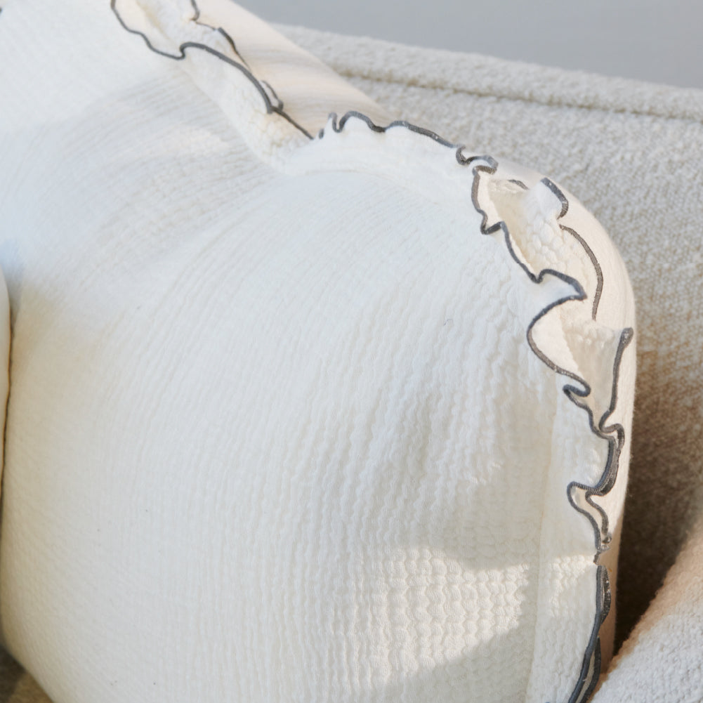 white coloured cushion in a soft fabric with a double flange design and contrast stitching detail