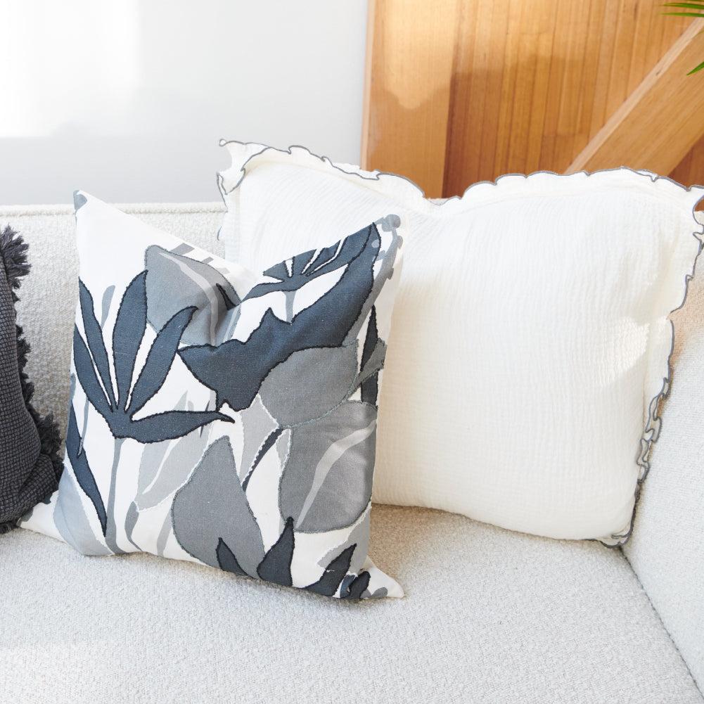 white coloured cushion in a soft fabric with a double flange design and contrast stitching detail